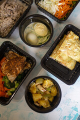 Healthy fitness food for the whole day. Several servings in containers on a blue background