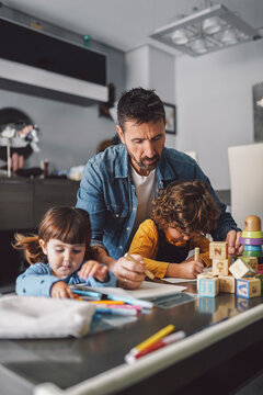 Father with his children drawing a picture