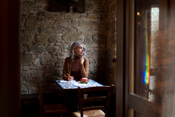 Lonely Woman drinking a coffee at the cafè