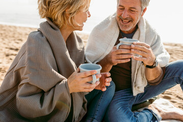Mature couple having a picnic at the beach