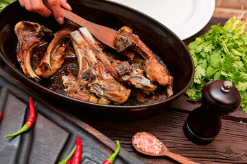 Roasted lamb ribs on frying pan close