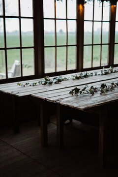 Table decorated for Christmas with pine leaves.