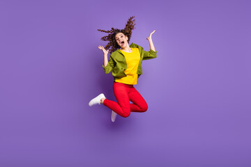 Full size photo of young happy shocked amazed surprised girl jumping in excitement isolated on violet color background