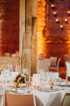 Beautiful table set indoors for reception with mood lighting in historic building