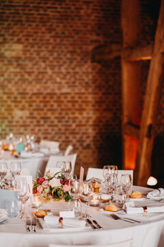 Beautiful table set indoors for reception with candlelight in historic building