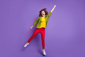 Full size photo of young happy smiling cheerful excited crazy girl with curls jumping isolated on violet color background