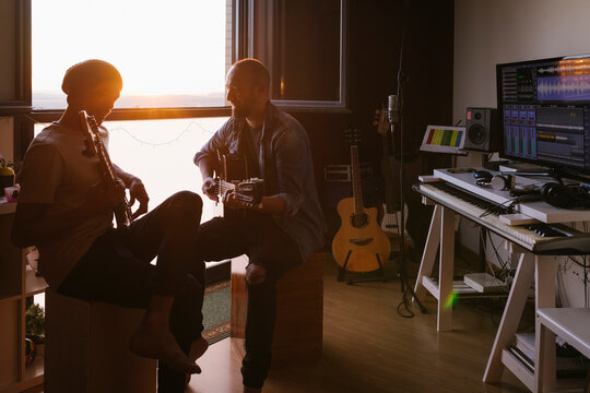 Musicians producing music in home recording studio