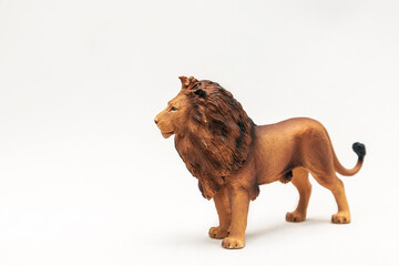A beautiful miniature lion made of rubber or plastic. The perfect animal toy for kids. Isolate....