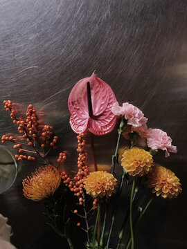 Various flowers on a metal table