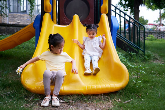 Cute Little Asian Girls Playing On The Slide In The Farm