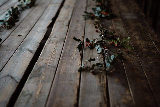 Table decorated for Christmas with pine leaves.
