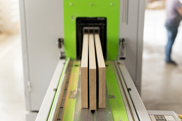 The close up of decorative not chipped wooden blocks in green cutting machine