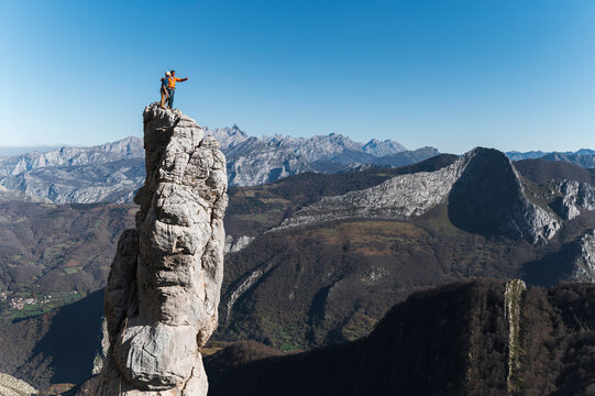 Climbing partners taking selfie on top of pinnacle