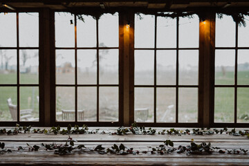 Table decorated for Christmas with pine leaves.