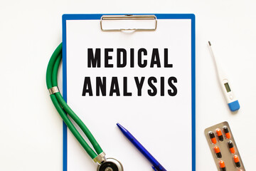 Text MEDICAL ANALYSIS in the folder with the stethoscope. Medical concept.