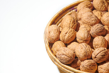 Walnuts in a basket on a white background