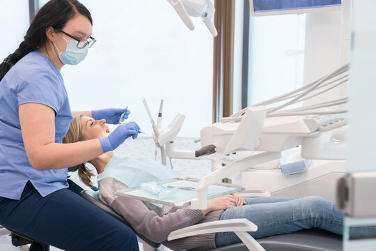 Dentist Providing Treatment For Patient