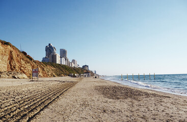 Israel, Netanya: Scenic view of the beach with people and  cityscape on the hill 