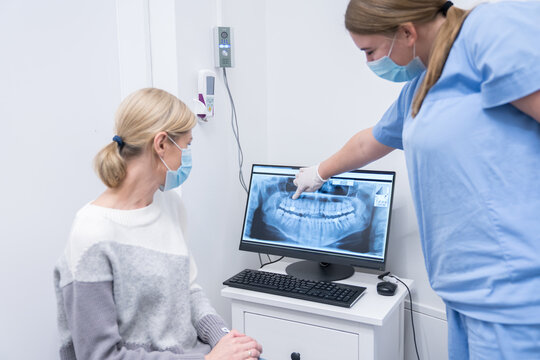 Dentist And Patient Talking About X-Ray