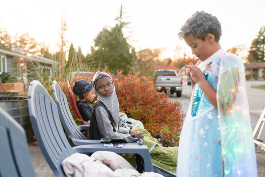 Siblings eat candy on Halloween