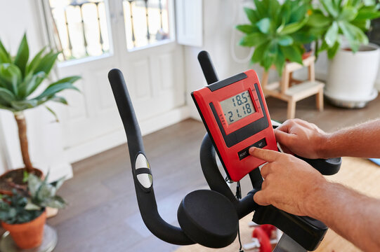 Man adjusting his stationary bike settings