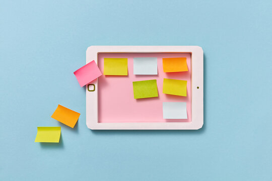 Paper note sheets on a papercraft tablet screen.