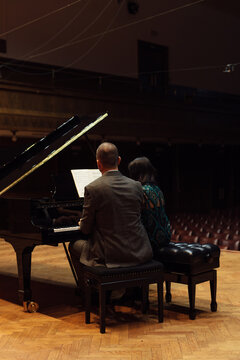Man and woman, playing a piano