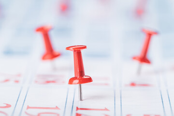Calendar page for 2021, Concept image of a calendar with red push pins.