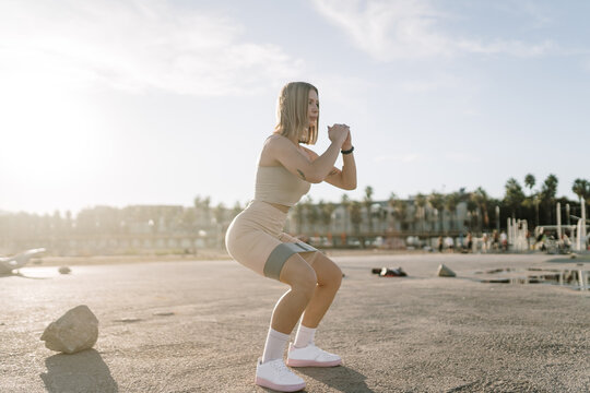 Woman doing a squat with resistance bands