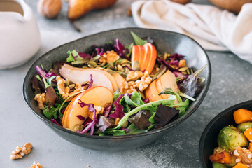 Delicious salad with apple, pear and walnuts