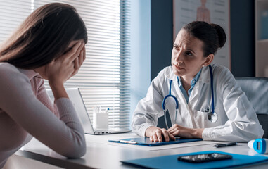 Doctor assisting a crying patient in the office