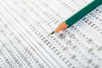 testing in exercise and exam paper. computer sheet with pencil in school test room, education concept. filling in answers in pencil