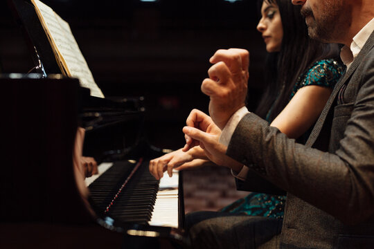 Man and woman, playing a piano