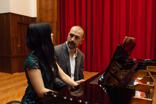 Man and woman, playing a piano