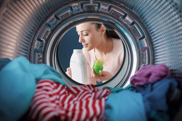 Woman smelling a scented laundry detergent