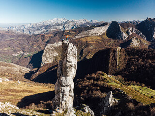 Climbing partners celebrating summit with open arms