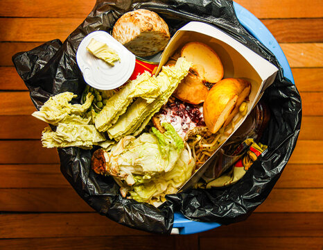 A garbage can with unused food. Food waste as a global problem in the world.