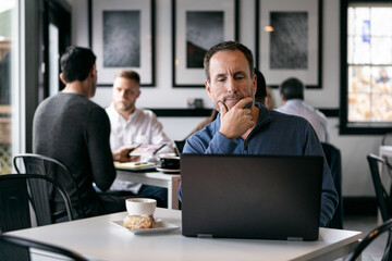 Business: Man Working Alone In Coffee House