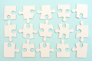 White puzzle on a blue background top view.