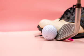 Golf ball with golf club are on pink background