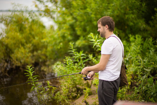 a man catches fish on the river, selective focus