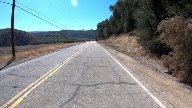 POV Driving Down An Empty Two Lane Road In California