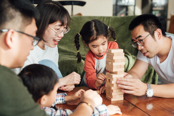 Parents and kids playing game at home