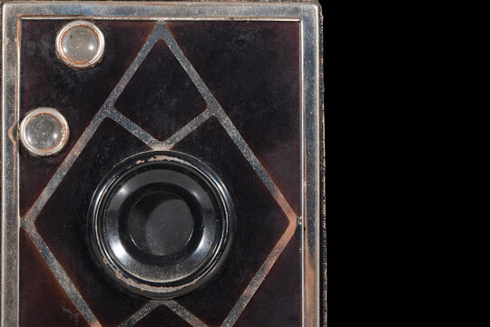 Fragment of an old photo camera on a black background.