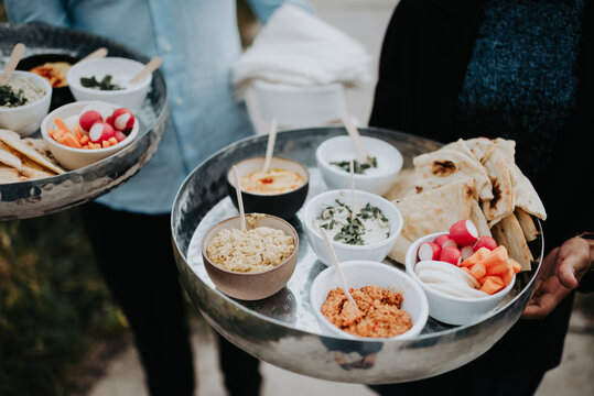 serving all kind of snacks and disches on two silver Moroccan servers