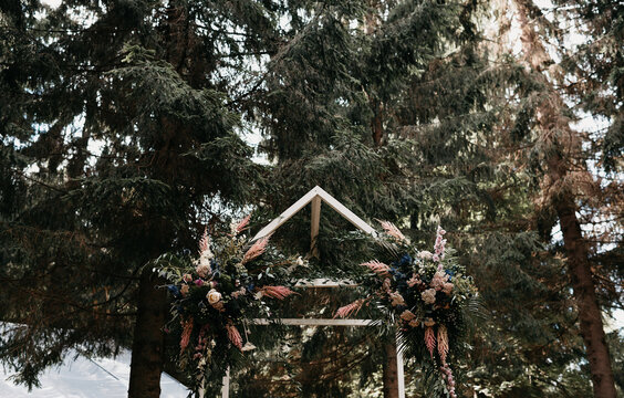 small wooden construction with flower arrangement in the woods