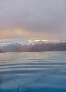 an outdoor swimming pool on the edge of the hill