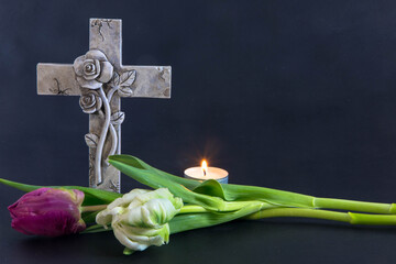 Ornate cross with tulips on a dark background.
Condolence card. Empty place for emotional...