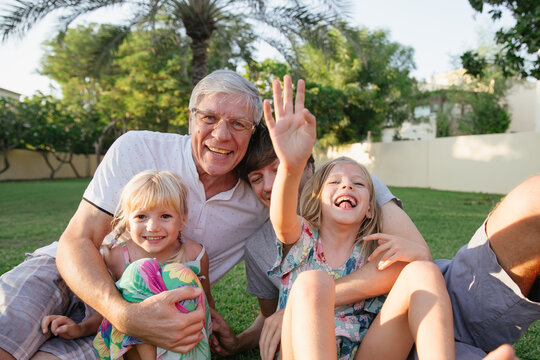 Portrait of a grandfather with his son and two granddaughters