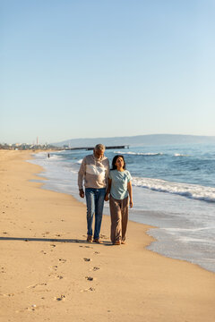 Senior Couple Walks On the Sand